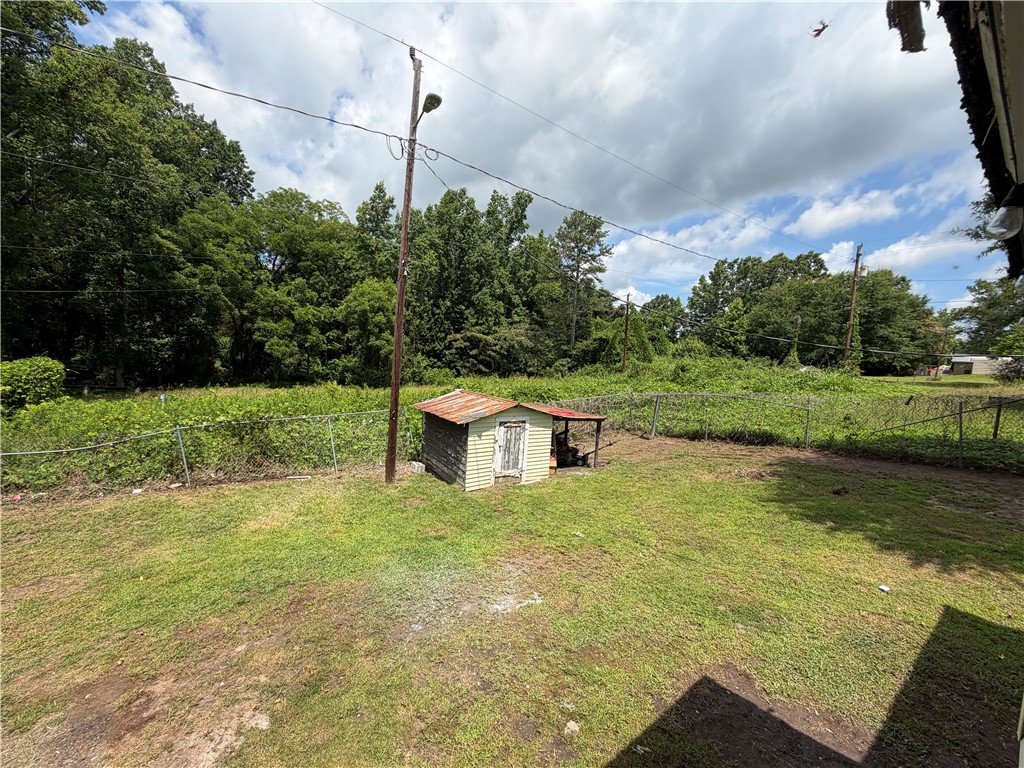302 Sirrine Street Honea Path, SC 29654 - Photo 24 of 24 A quaint storage shed offers functional utility within this fenced, verdant yard.
