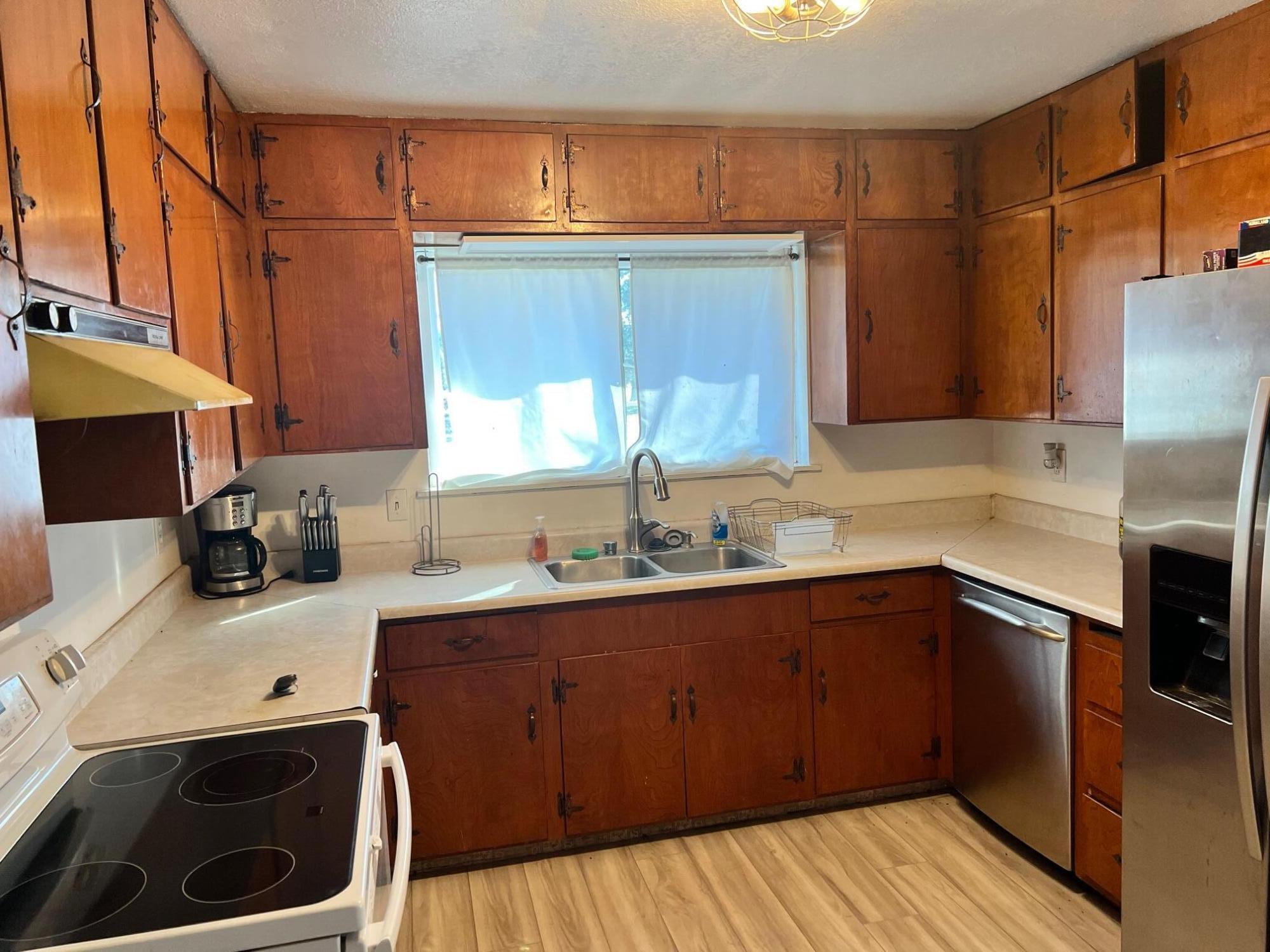 44619 Cornell Road Fall River Mills, CA 96028 - Photo 7 of 17 a kitchen with a sink a stove and cabinets