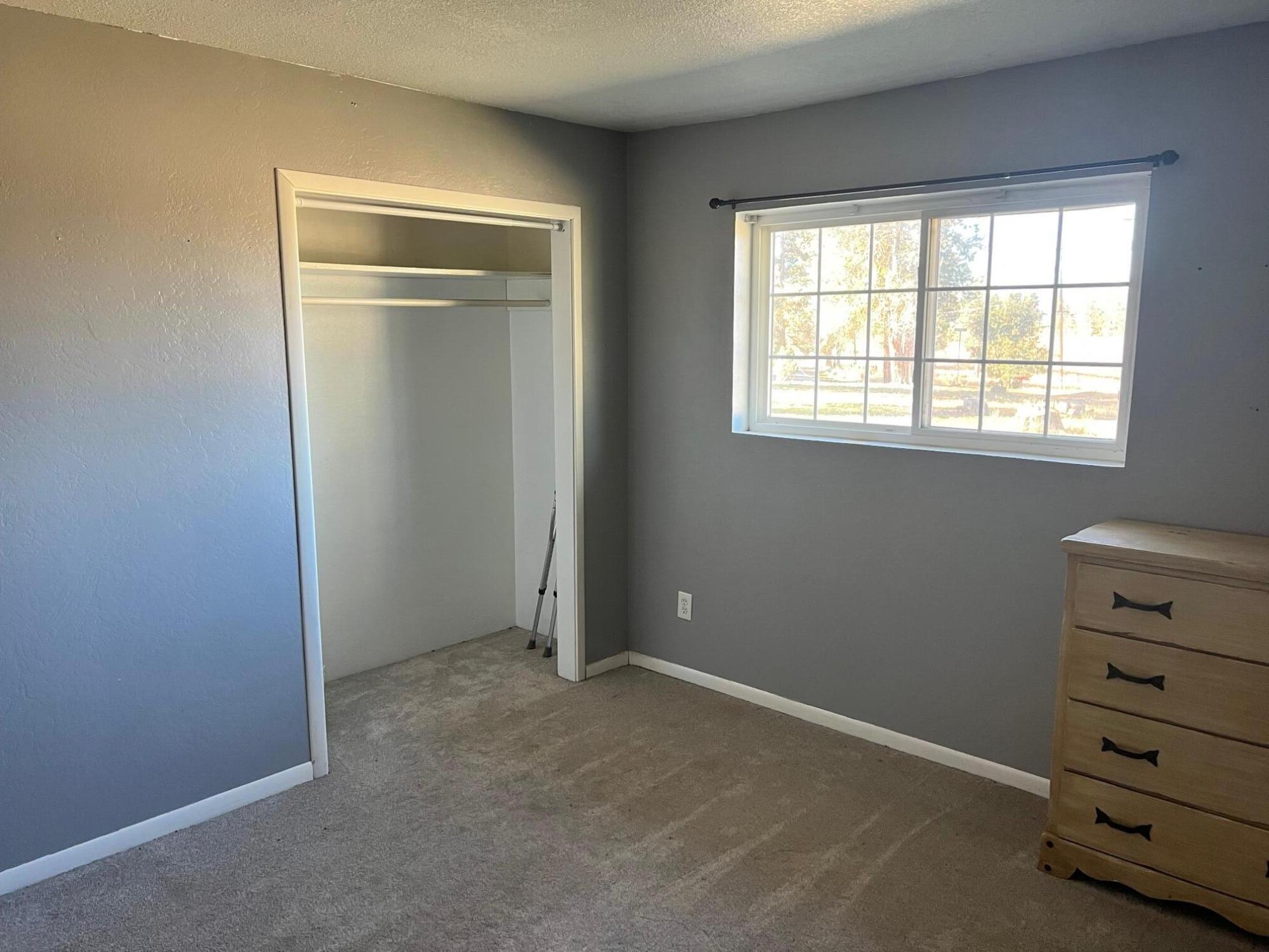 44619 Cornell Road Fall River Mills, CA 96028 - Photo 10 of 17 an empty room with a dresser and a window
