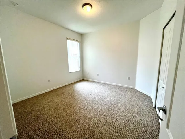a view of a big room with a ceiling fan