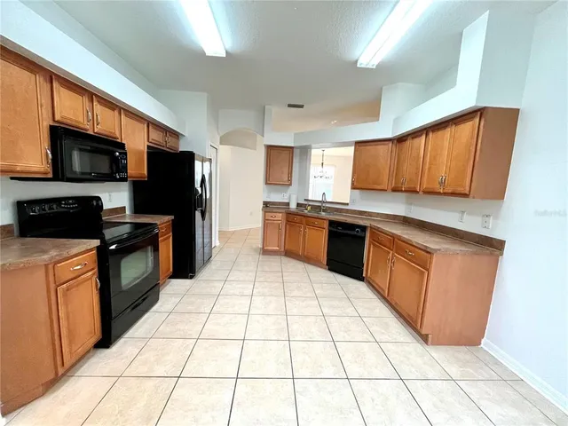 a kitchen with stainless steel appliances a sink stove and a window