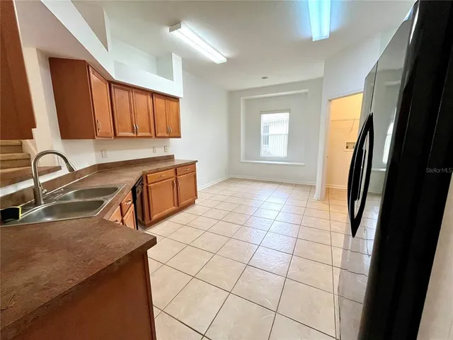 a large kitchen with cabinets and stainless steel appliances