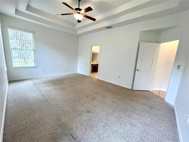 a view of a livingroom with a ceiling fan and window