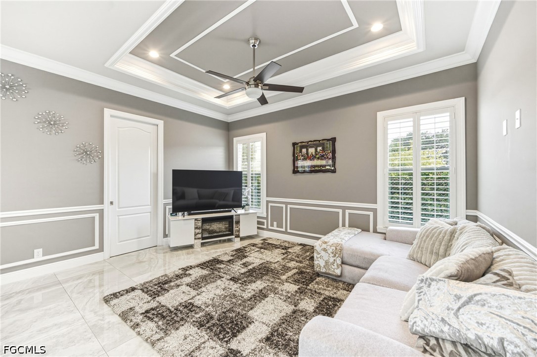 1700 43rd Terrace Southwest Naples, FL 34116 - Photo 19 of 38 a living room with furniture and a flat screen tv