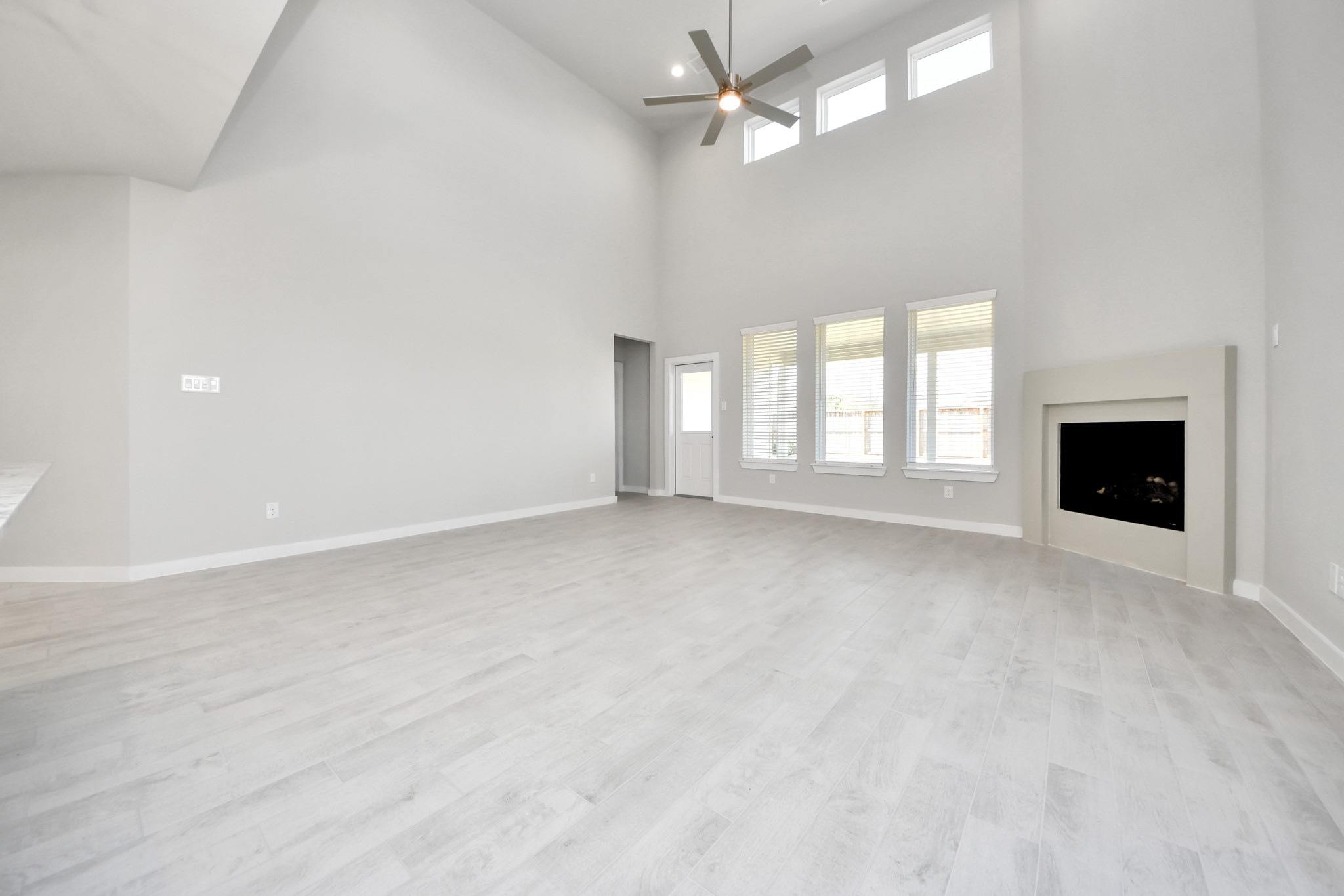 2922 Burris Park Drive Spring, TX 77373 - Photo 16 of 37 Welcome family and guests to your charming living room! With its high ceilings, recessed lighting, ceiling fan, custom paint, beautiful flooring, and large windows that let in abundant natural light, this room is perfect for gatherings. Sample photo of completed home with similar floor plan. Actual colors and selections may vary.