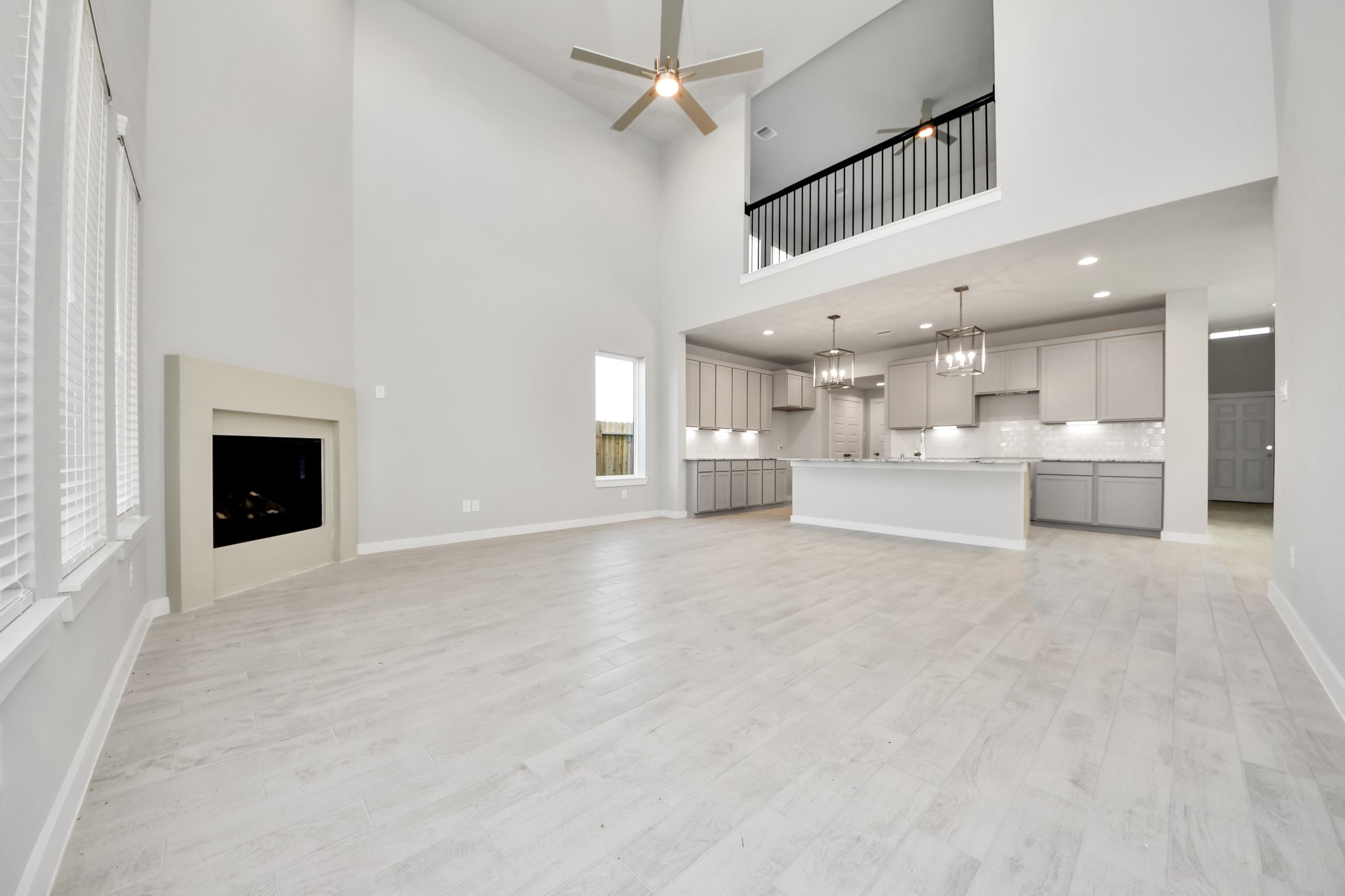 2922 Burris Park Drive Spring, TX 77373 - Photo 18 of 37 Family room flooded with natural light through the expansive windows. The premium tile flooring adds a touch of luxury to the space, creating the perfect setting for relaxing moments and cherished gatherings with loved ones. Sample photo of completed home with similar floor plan. Actual colors and selections may vary.
