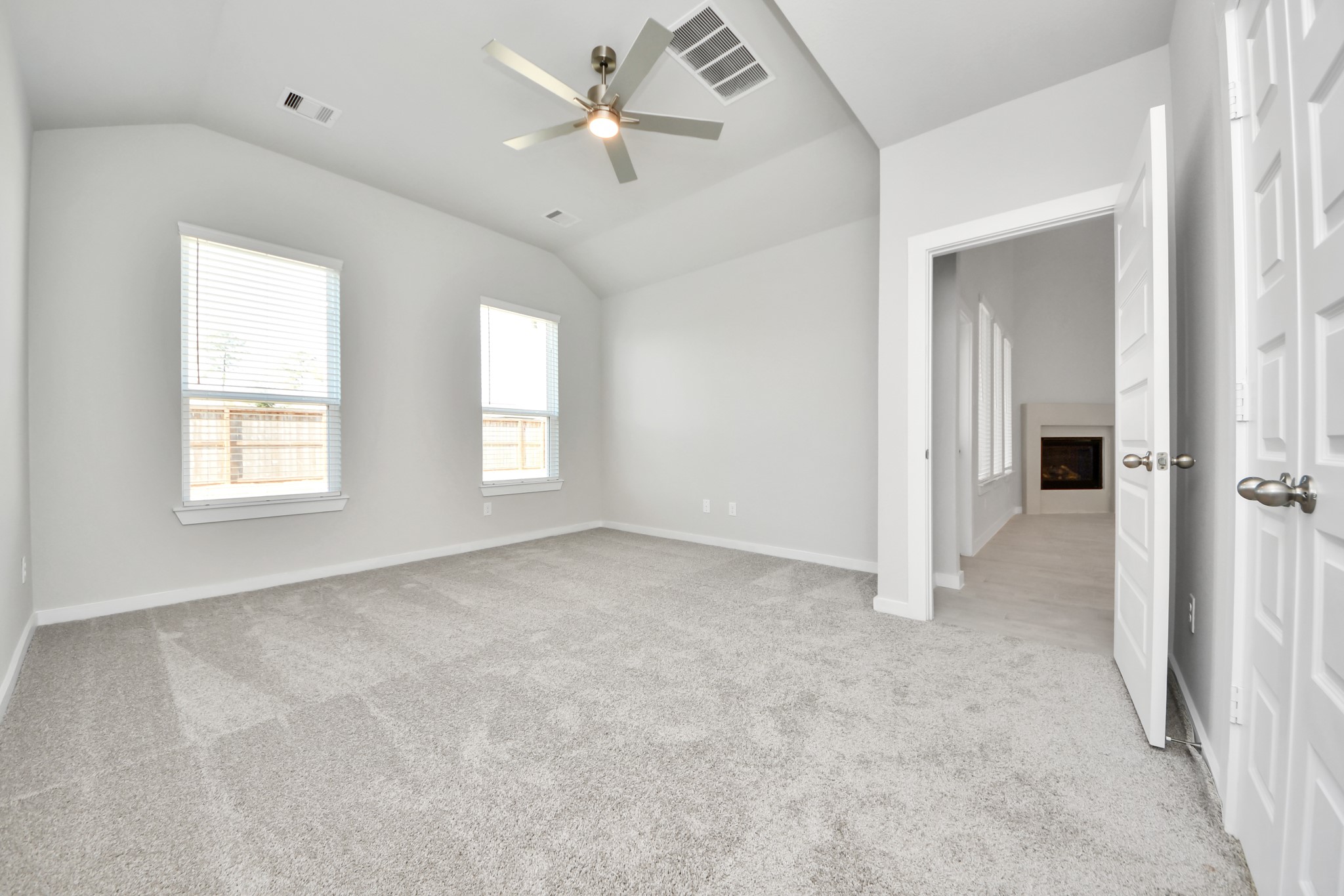 2922 Burris Park Drive Spring, TX 77373 - Photo 20 of 37 Come and unwind after a long day in this magnificent primary suite! This spacious room features plush carpet, warm paint, high ceilings and large windows with privacy blinds. Sample photo of completed home with similar floor plan. Actual colors and selections may vary.