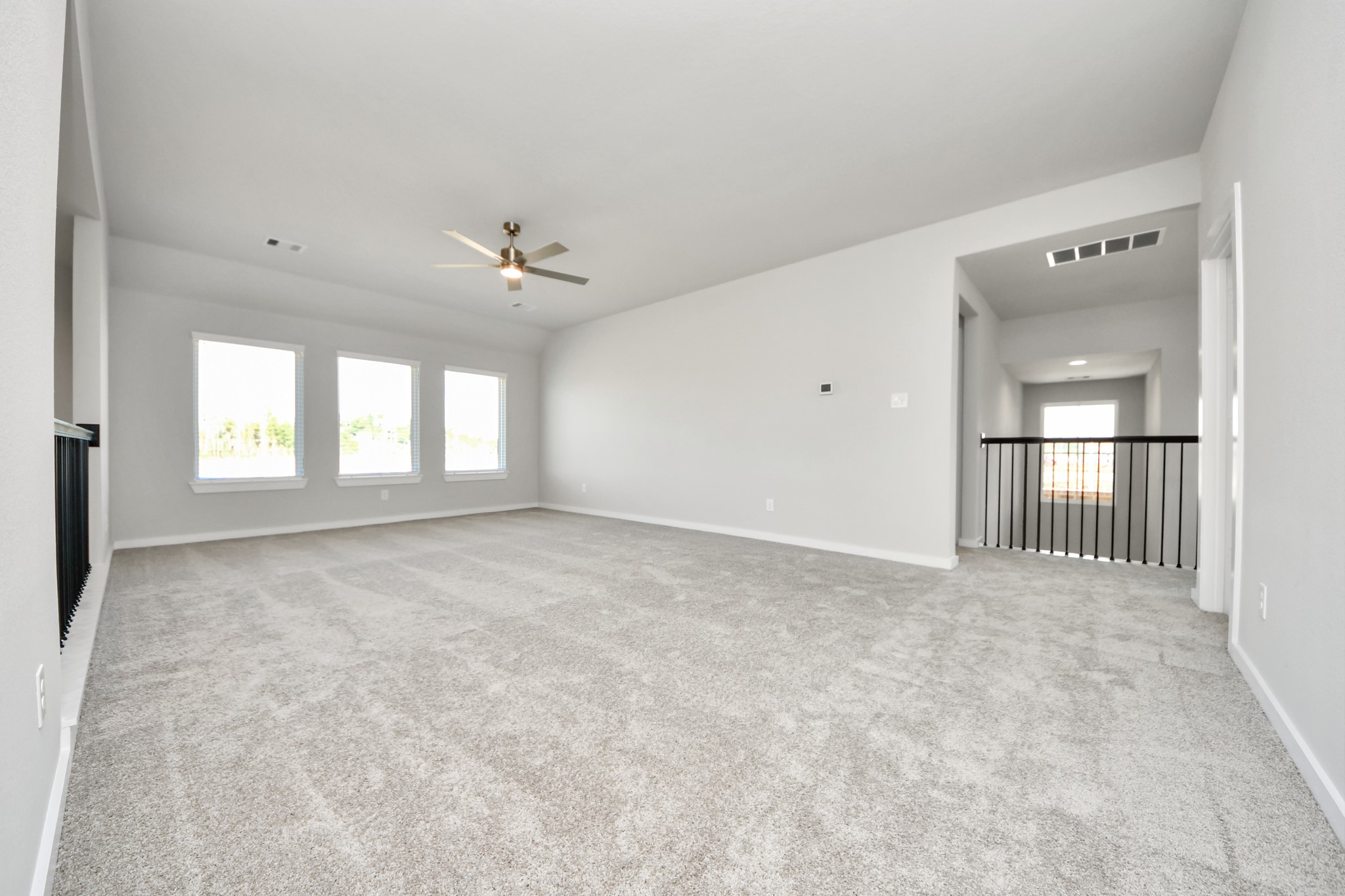 2922 Burris Park Drive Spring, TX 77373 - Photo 28 of 37 Discover a haven of leisure in this fantastic game room! Whether you're seeking a casual hangout or an adult gaming retreat, this space has it all. Enjoy the luxurious feel of plush carpet underfoot, the expansive ambiance of high ceilings, custom paint that adds a touch of personality, and windows that flood the room with refreshing natural light. Sample photo of completed home with similar floor plan. Actual colors and selections may vary.