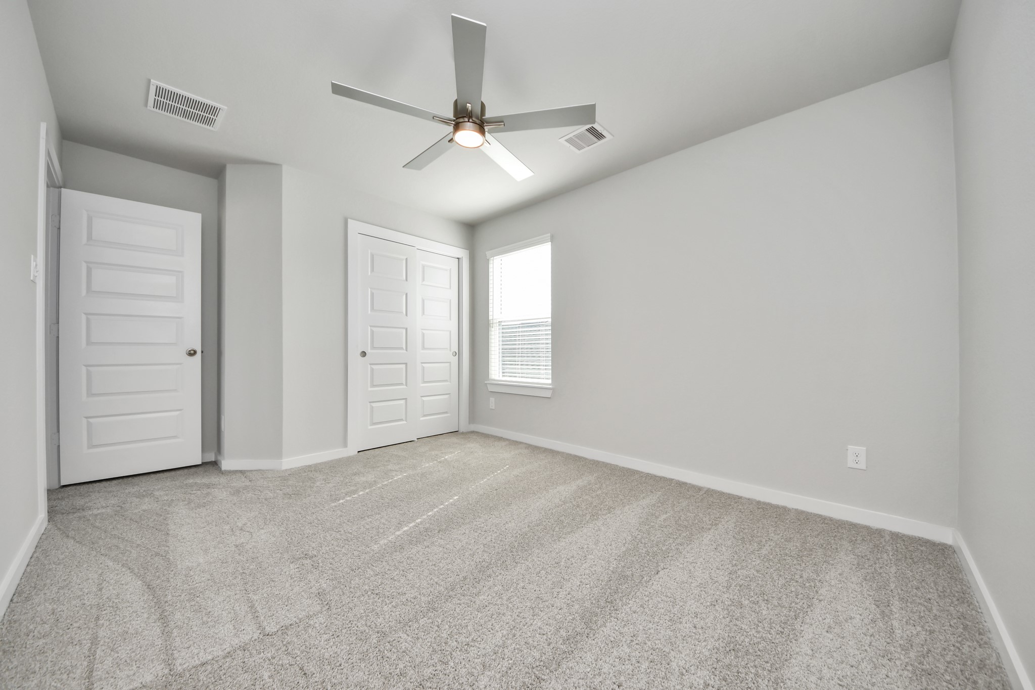 2922 Burris Park Drive Spring, TX 77373 - Photo 29 of 37 Generously sized secondary bedrooms featuring spacious closets, soft and inviting carpeting underfoot, large windows allowing plenty of natural light, and the added touch of privacy blinds for your personal retreat. Sample photo of completed home with similar floor plan. Actual colors and selections may vary.