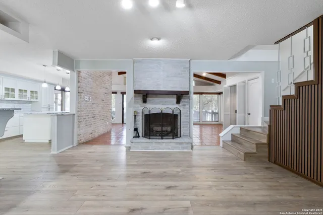 a view of a livingroom with an empty space and a fireplace
