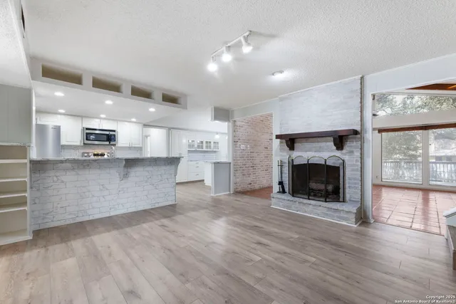 a view of kitchen with granite countertop cabinets and wooden floor