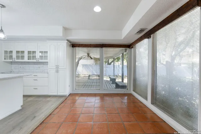 a view of empty room with wooden floor and fireplace