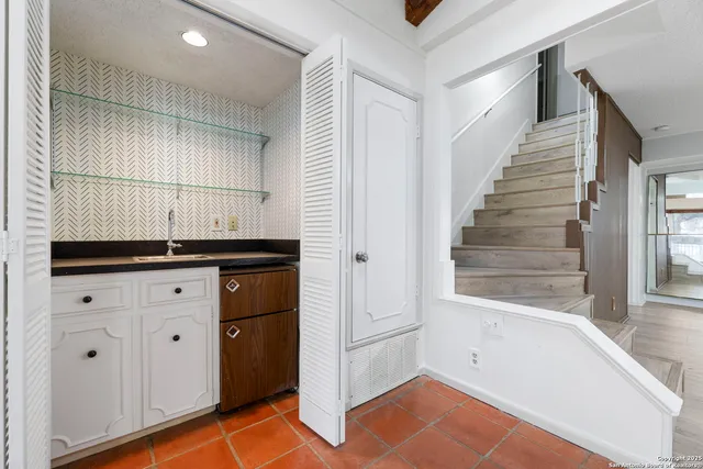 a spacious bedroom with a large bed and a chandelier