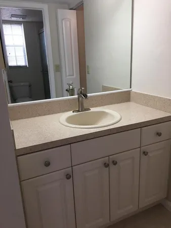 a view of a small space with wooden floor and a window