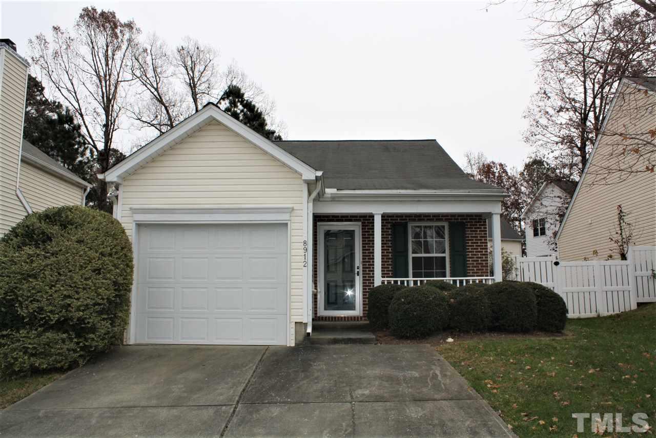 8912 Shallcross Way Raleigh, NC 27617 - Photo 1 of 20 a view of a house with a large window and a yard