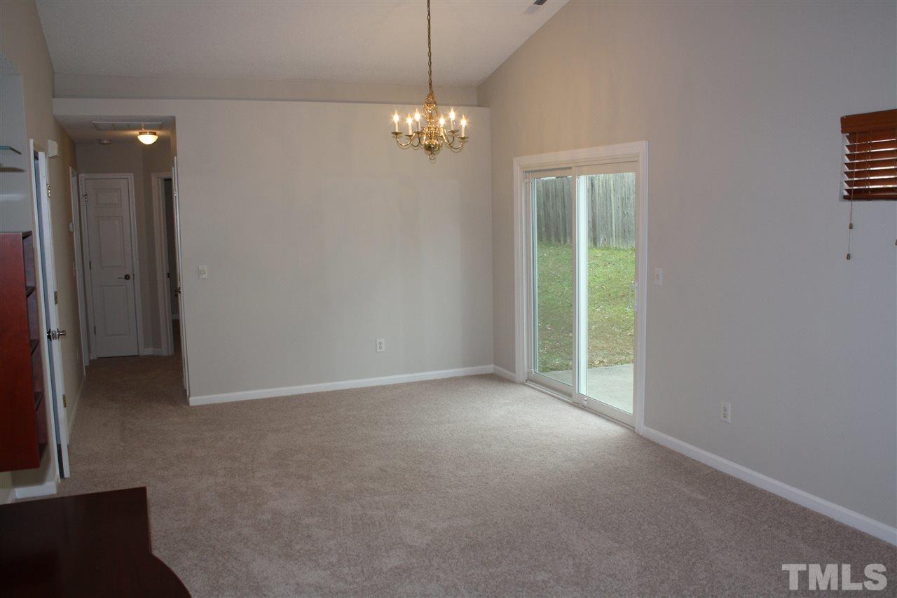 8912 Shallcross Way Raleigh, NC 27617 - Photo 11 of 20 a view of an empty room with window and chandelier fan