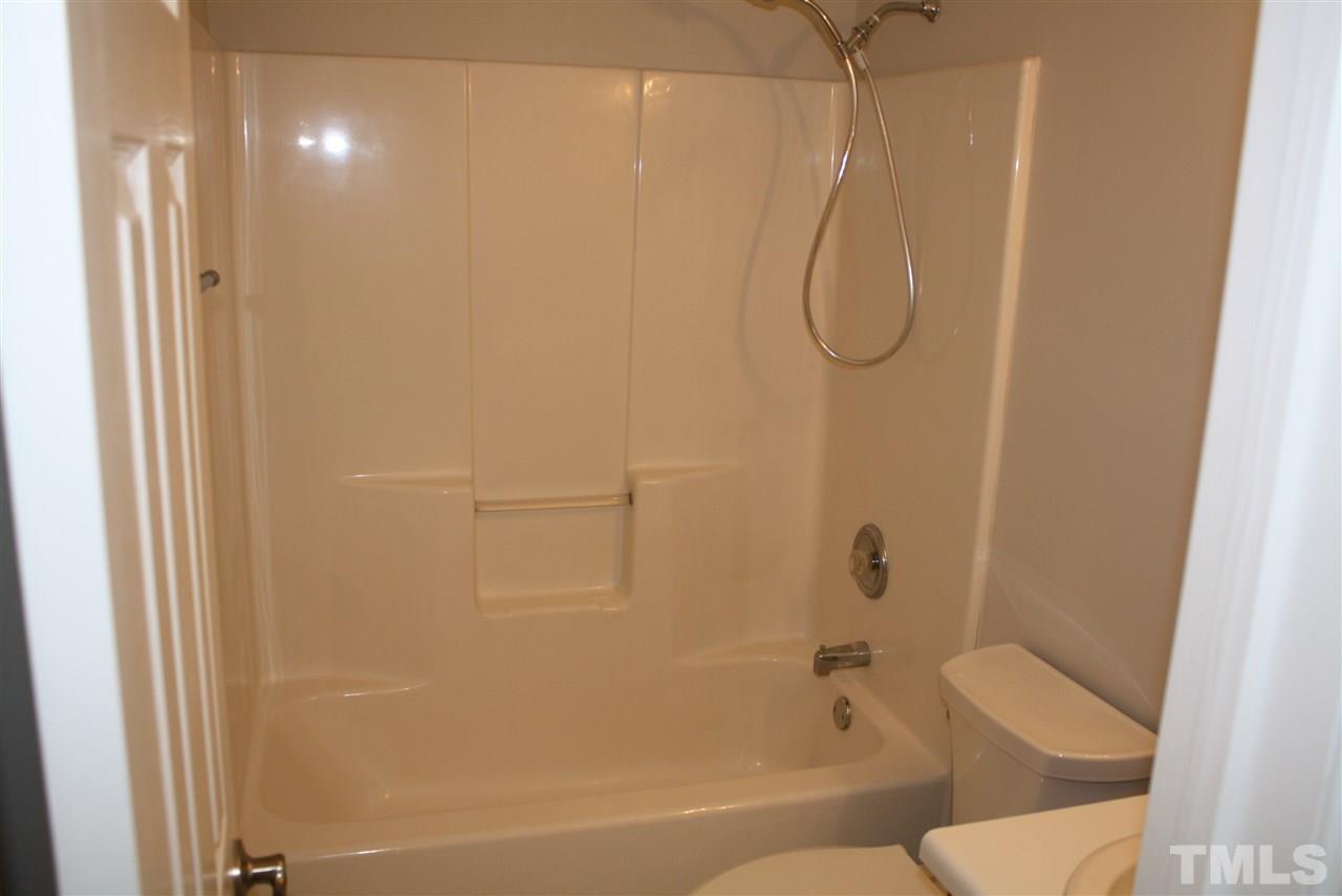 8912 Shallcross Way Raleigh, NC 27617 - Photo 14 of 20 a bathroom with a granite countertop shower and a toilet