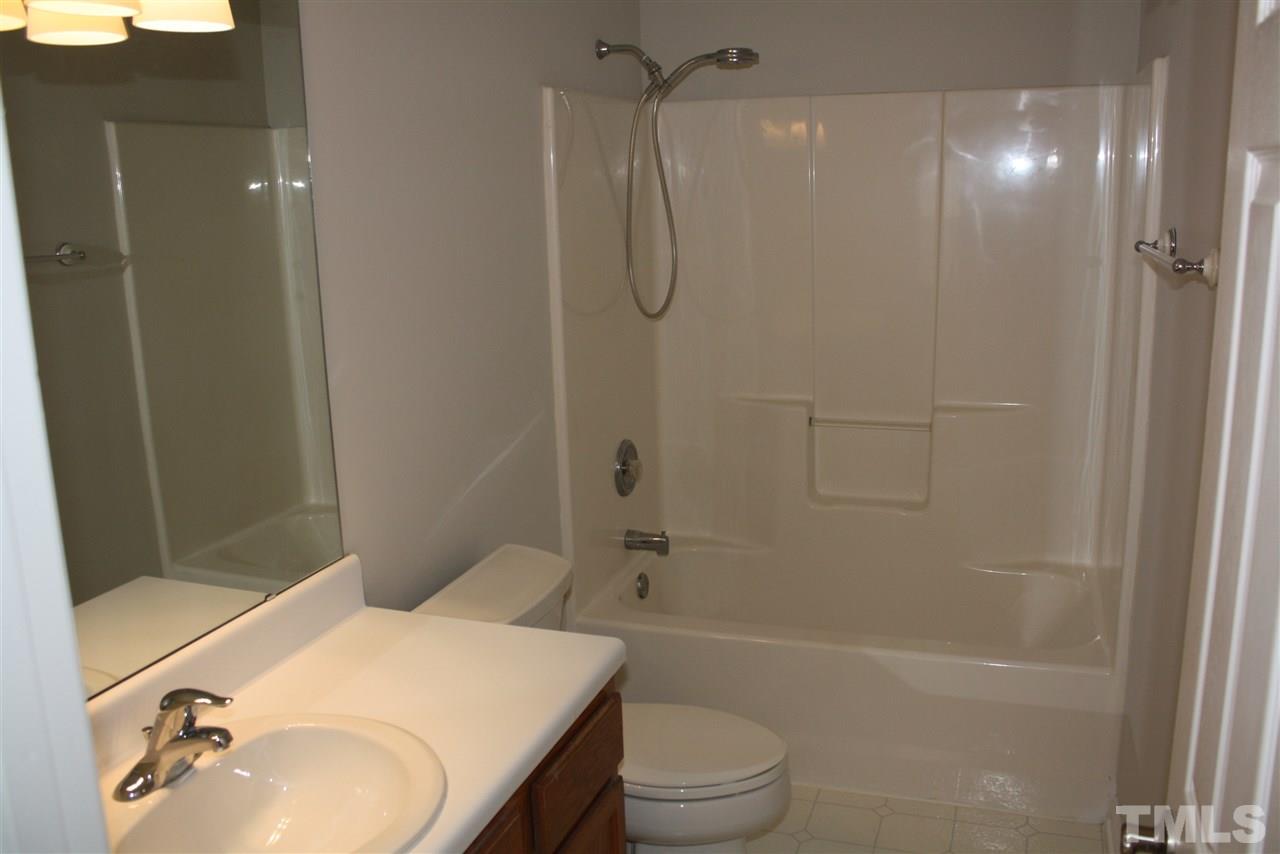 8912 Shallcross Way Raleigh, NC 27617 - Photo 16 of 20 a bathroom with a sink toilet and shower