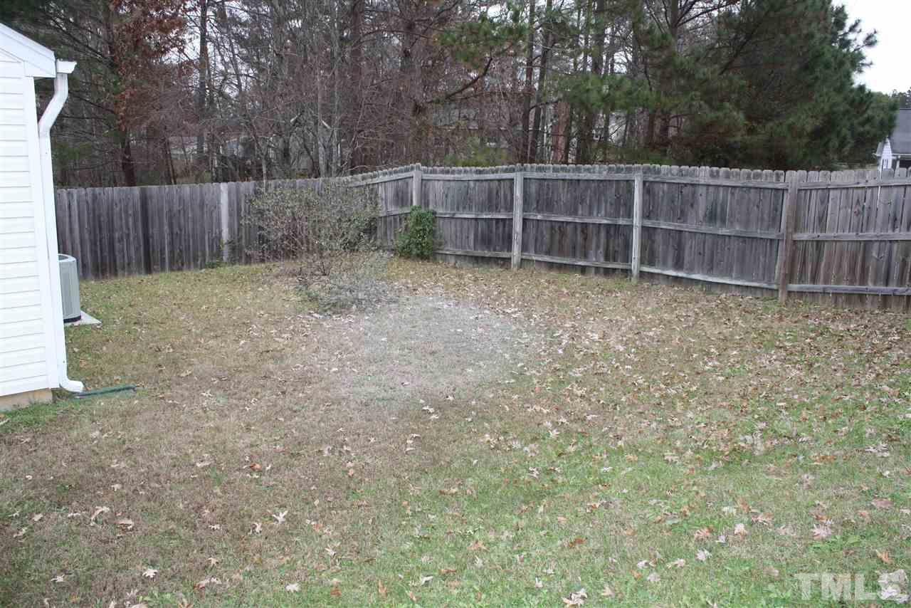 8912 Shallcross Way Raleigh, NC 27617 - Photo 20 of 20 a view of backyard with wooden fence and large trees