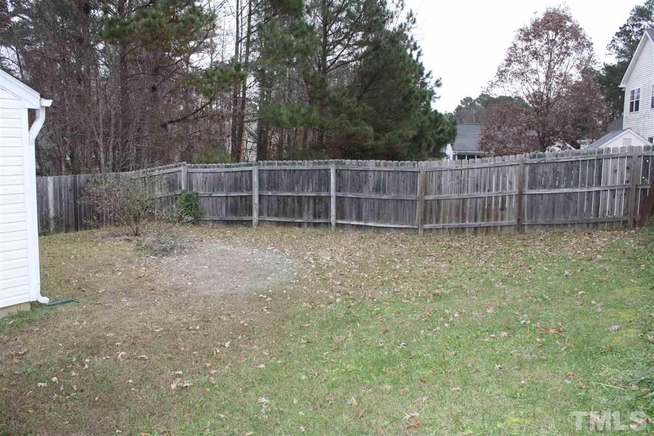 8912 Shallcross Way Raleigh, NC 27617 - Photo 4 of 20 a view of a backyard with a fence