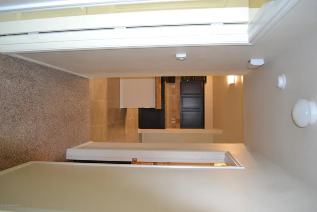 a bathroom with a tub and mirror