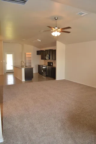 a view of a kitchen with a sink and a refrigerator
