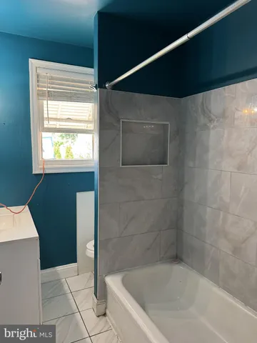 a bathroom with a bathtub and shower