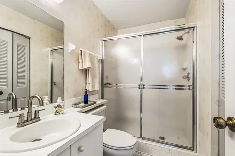 a bathroom with a sink toilet and shower