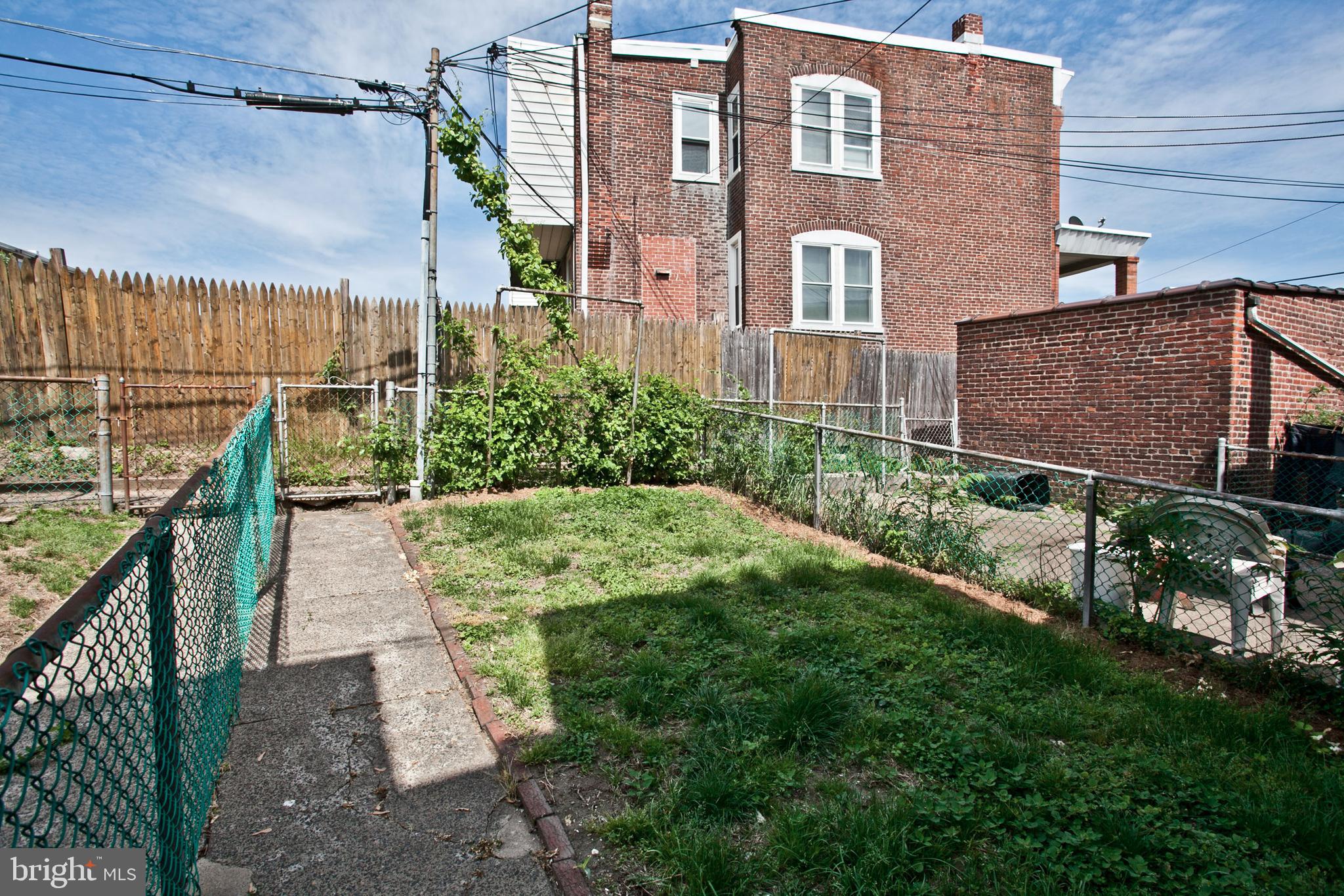 4205 Terrace Street Philadelphia, PA 19128 - Photo 29 of 30 a view of a brick building next to a yard