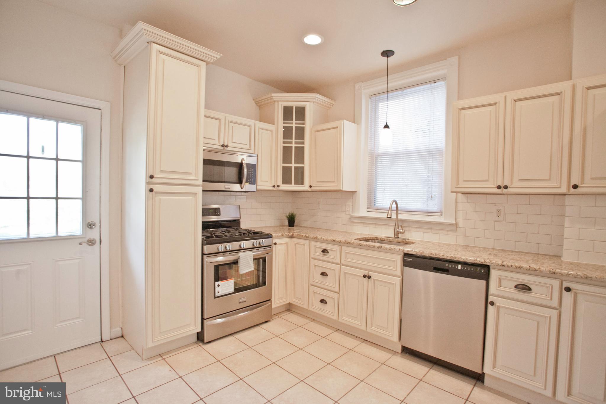 4205 Terrace Street Philadelphia, PA 19128 - Photo 7 of 30 a kitchen with white cabinets appliances and a window