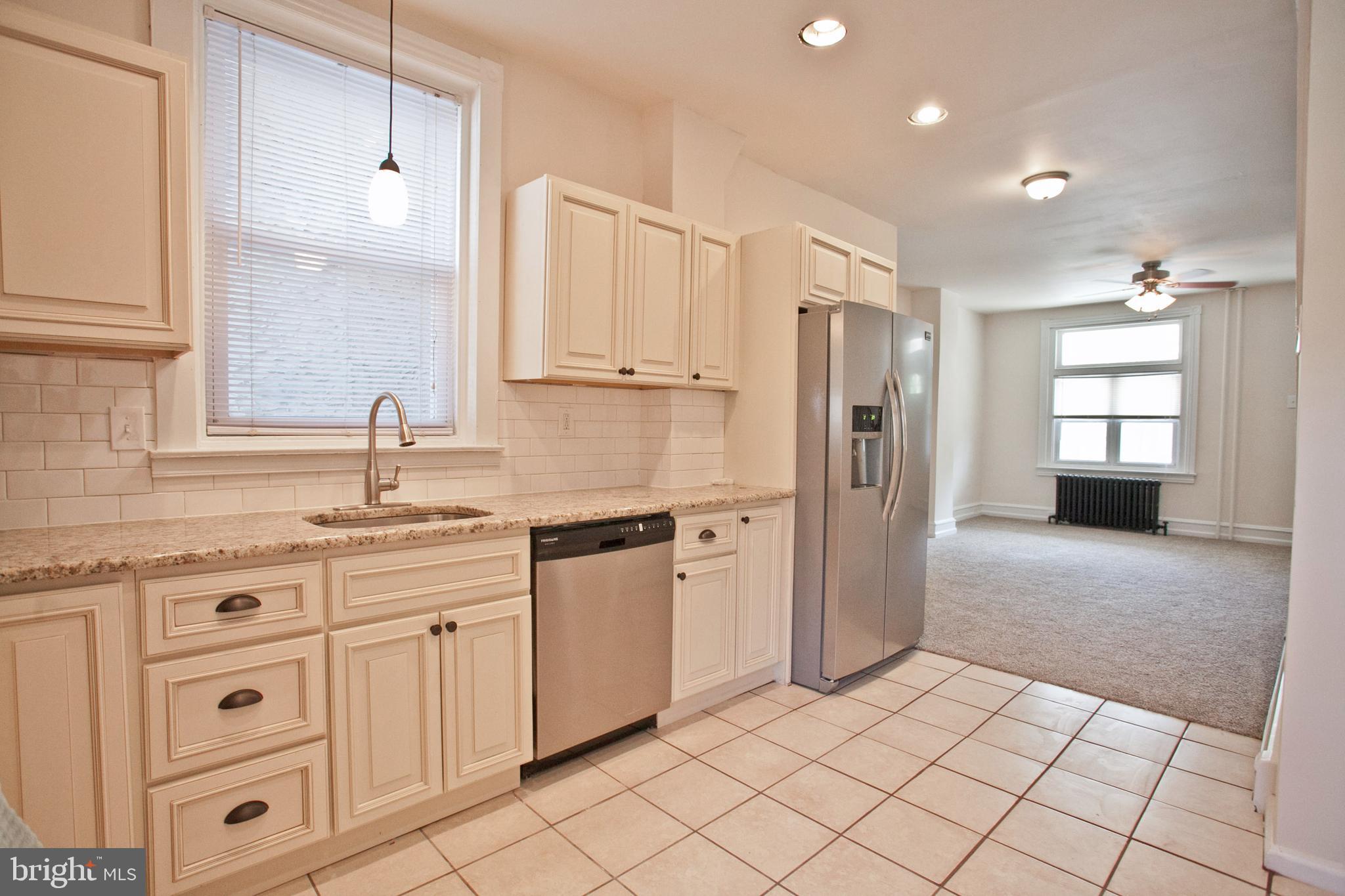 4205 Terrace Street Philadelphia, PA 19128 - Photo 8 of 30 a kitchen with stainless steel appliances granite countertop a sink and a refrigerator