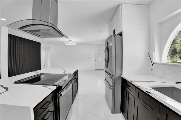 a kitchen that has a sink and a stove in it