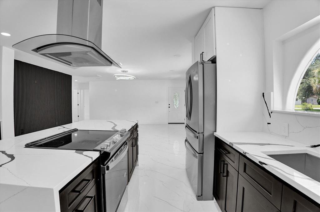 201 Massachusetts Avenue St. Cloud, FL 34769 - Photo 13 of 33 a kitchen that has a sink and a stove in it