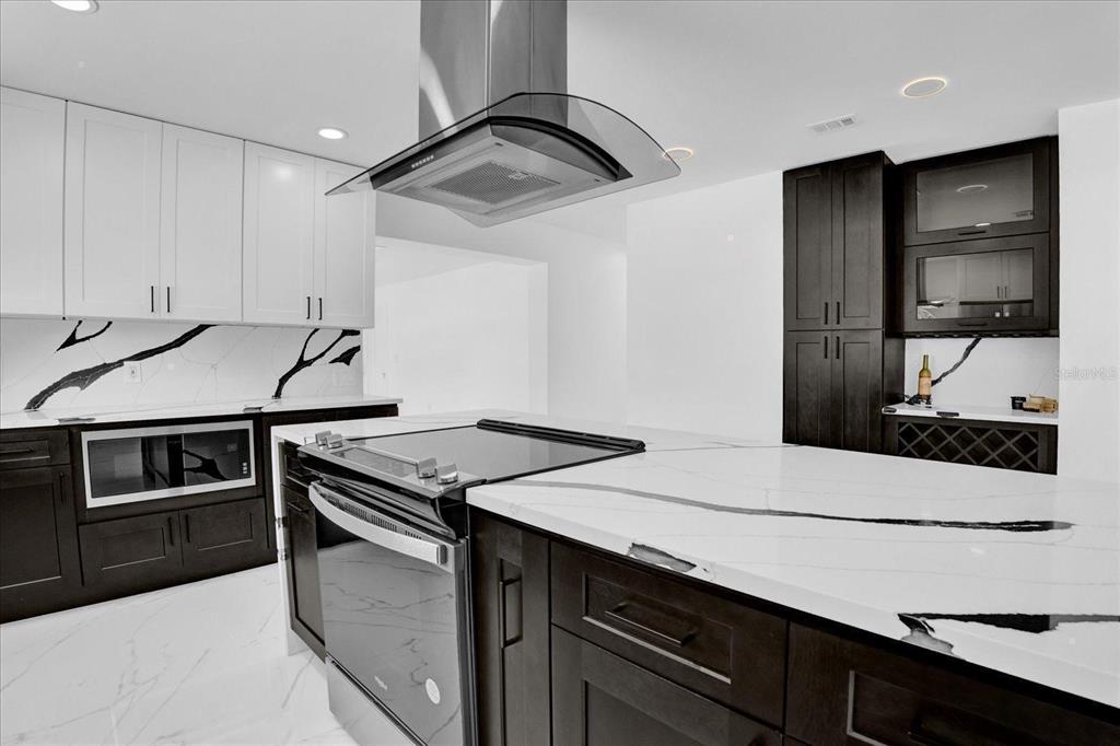 201 Massachusetts Avenue St. Cloud, FL 34769 - Photo 14 of 33 a kitchen with a stove and a microwave