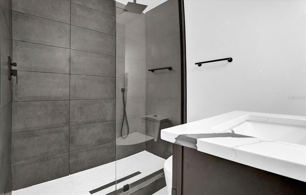 201 Massachusetts Avenue St. Cloud, FL 34769 - Photo 19 of 33 a bathroom with a sink a toilet and shower