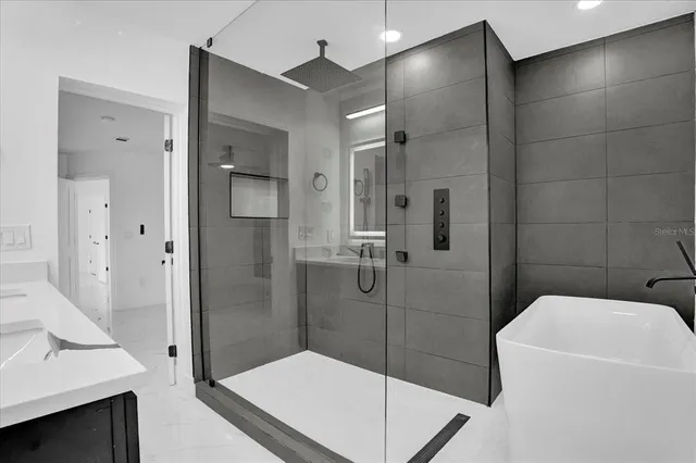 a bathroom with a granite countertop sink a toilet and a mirror