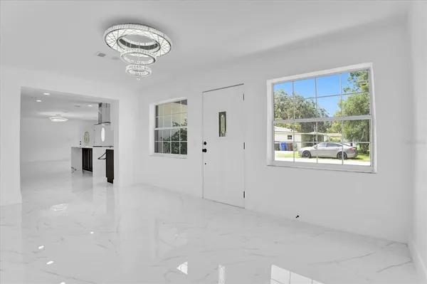 a view of empty room with wooden floor and window