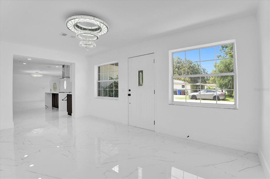 201 Massachusetts Avenue St. Cloud, FL 34769 - Photo 3 of 33 a view of empty room with wooden floor and window