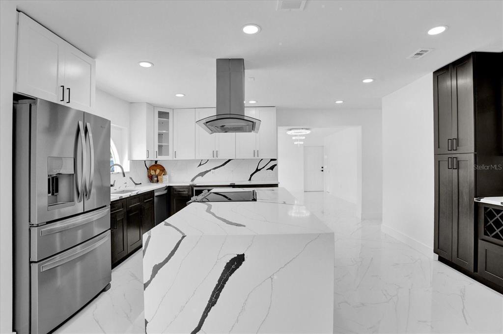 201 Massachusetts Avenue St. Cloud, FL 34769 - Photo 10 of 33 a kitchen with stainless steel appliances a refrigerator and a stove top oven