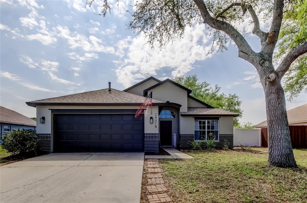 24318 Rolling View Court Lutz, FL 33559 - Photo 1 of 1 a front view of a house with a yard and garage