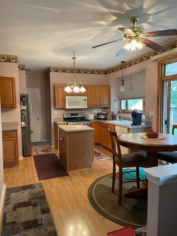 a kitchen with a dining table and chairs