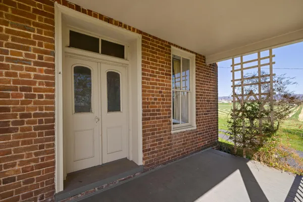a view of empty room with fireplace and windows