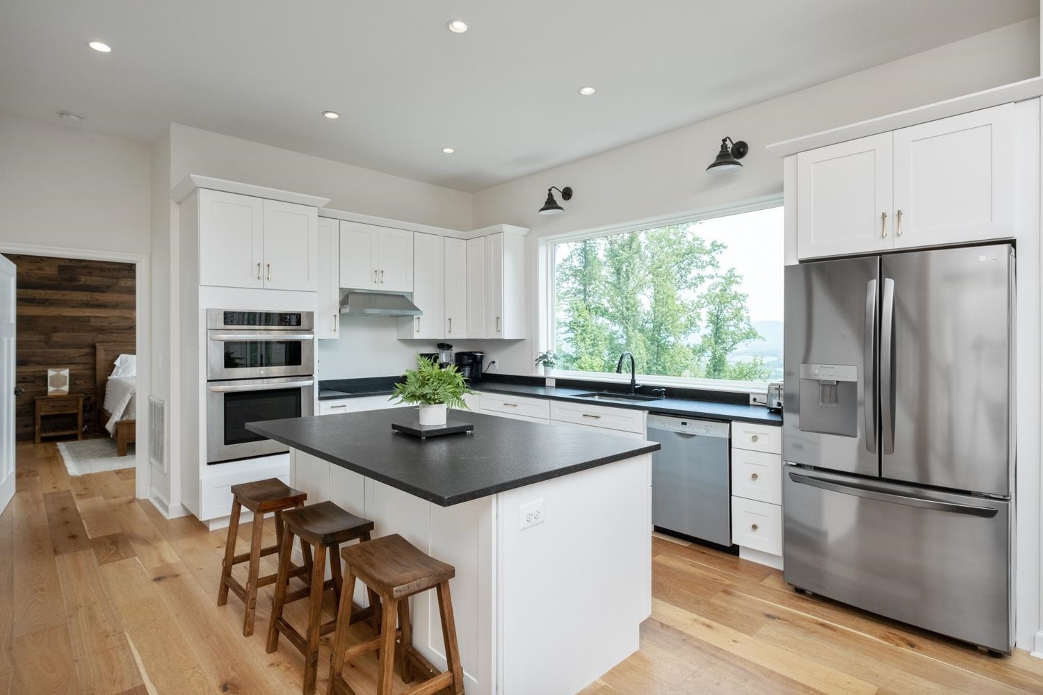 761 Top Ridge Road Stanardsville, VA 22973 - Photo 3 of 49 a kitchen with stainless steel appliances granite countertop a refrigerator a stove a sink dishwasher and a refrigerator with wooden floor