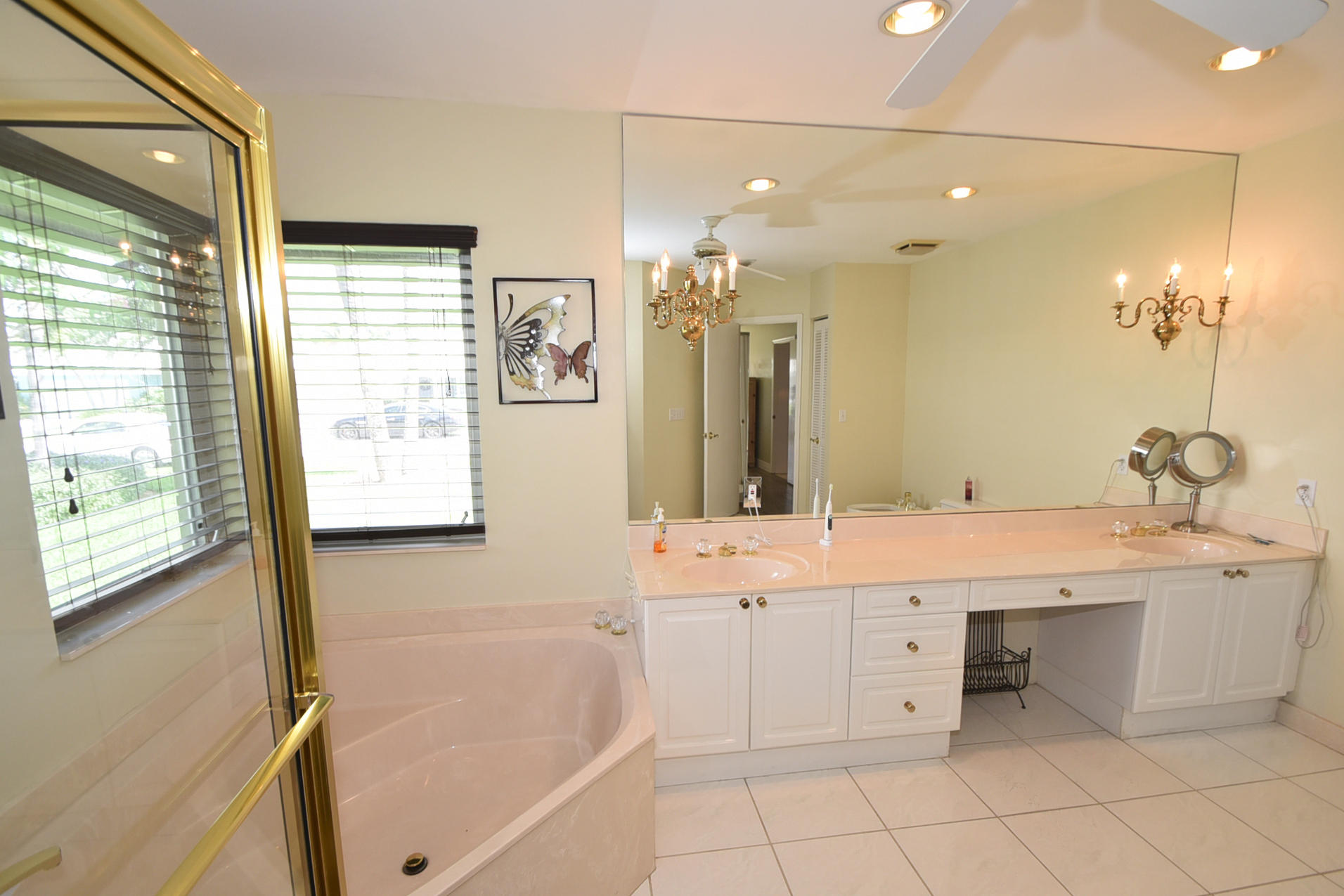736 Apple Tree Lane Boca Raton, FL 33486 - Photo 23 of 43 a bathroom with a bathtub sink and mirror