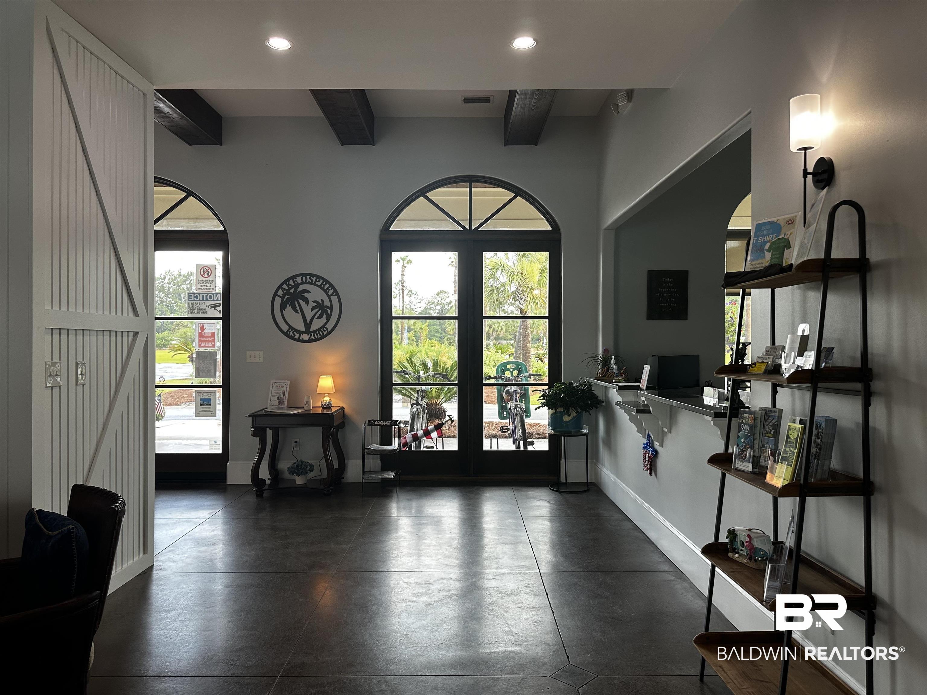 28085 Migratory Way Elberta, AL 36530 - Photo 13 of 59 Entryway featuring french doors, finished concrete flooring, recessed lighting, healthy amount of natural light, and beamed ceiling