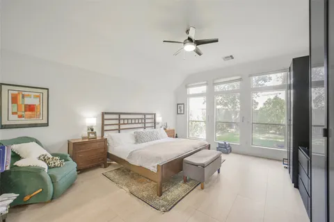 a bedroom with a bed and a ceiling fan