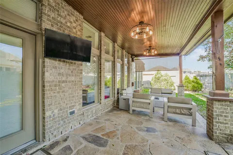 a view of a patio with table and chairs and wooden fence