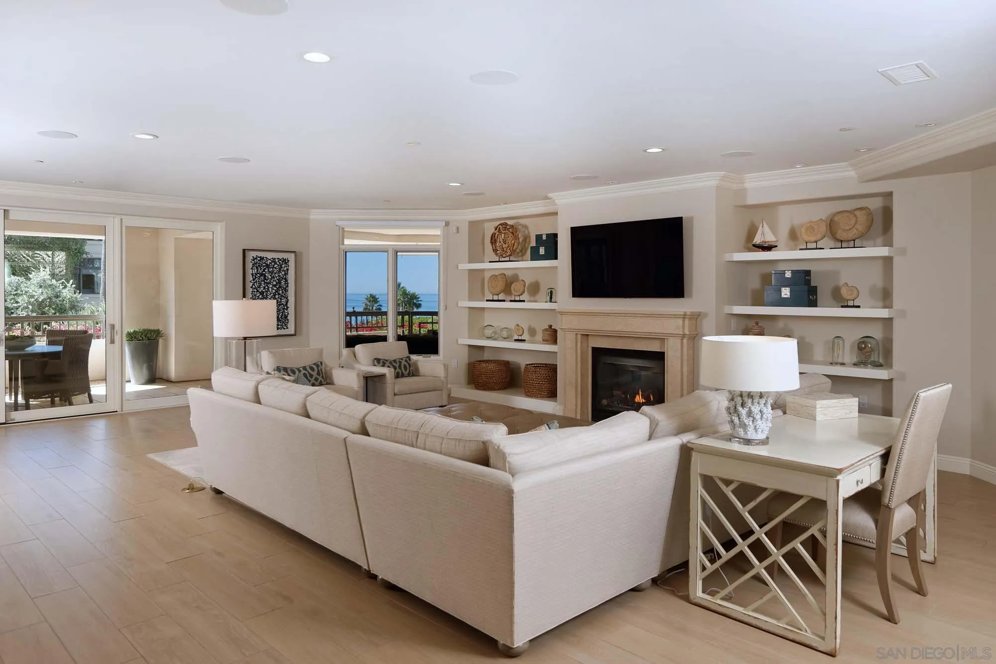 464 Prospect Street, Unit 101 La Jolla, CA 92037 - Photo 1 of 43 a living room with furniture a flat screen tv and a fireplace