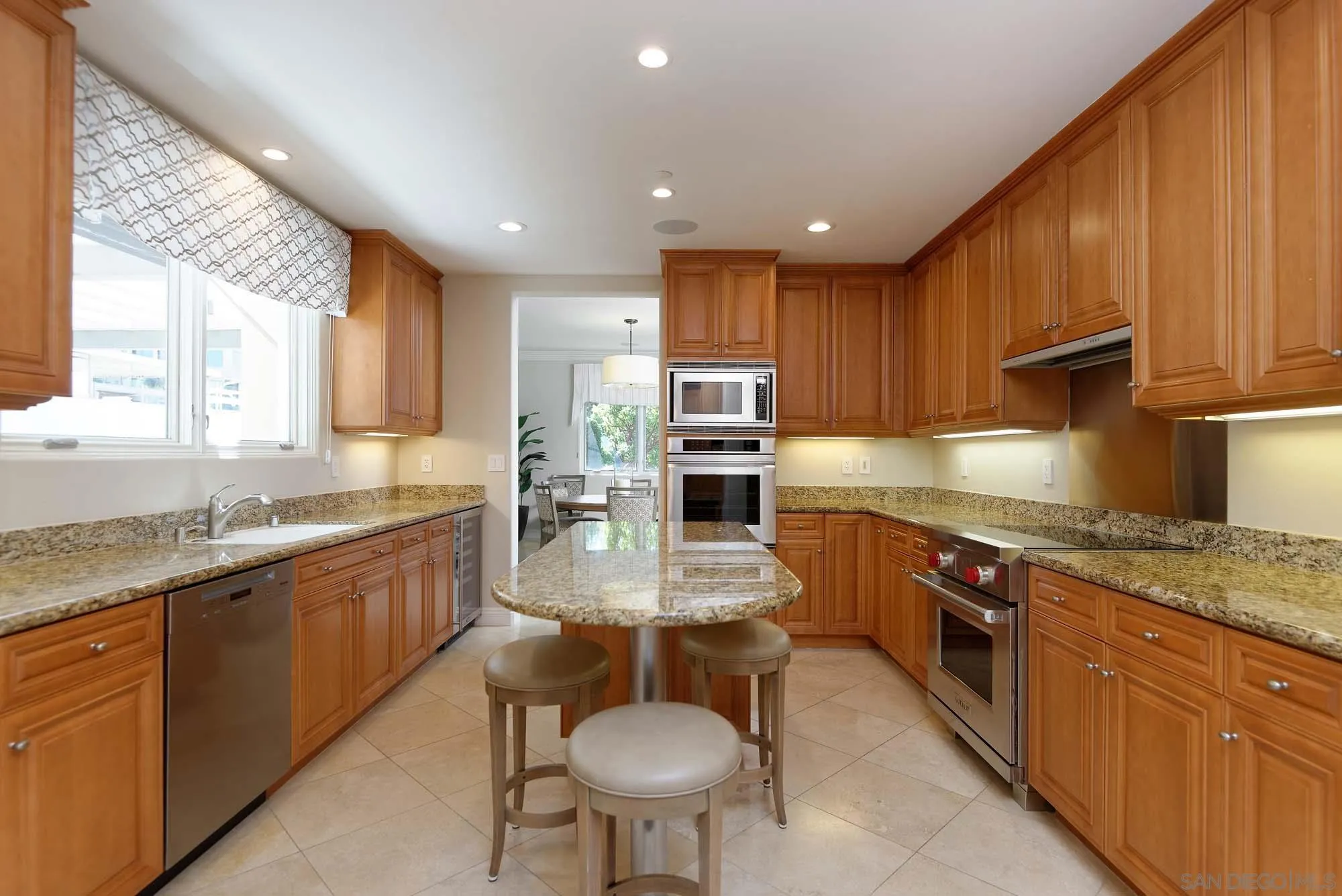 464 Prospect Street, Unit 101 La Jolla, CA 92037 - Photo 11 of 43 a large kitchen with stainless steel appliances granite countertop a sink a stove and a refrigerator