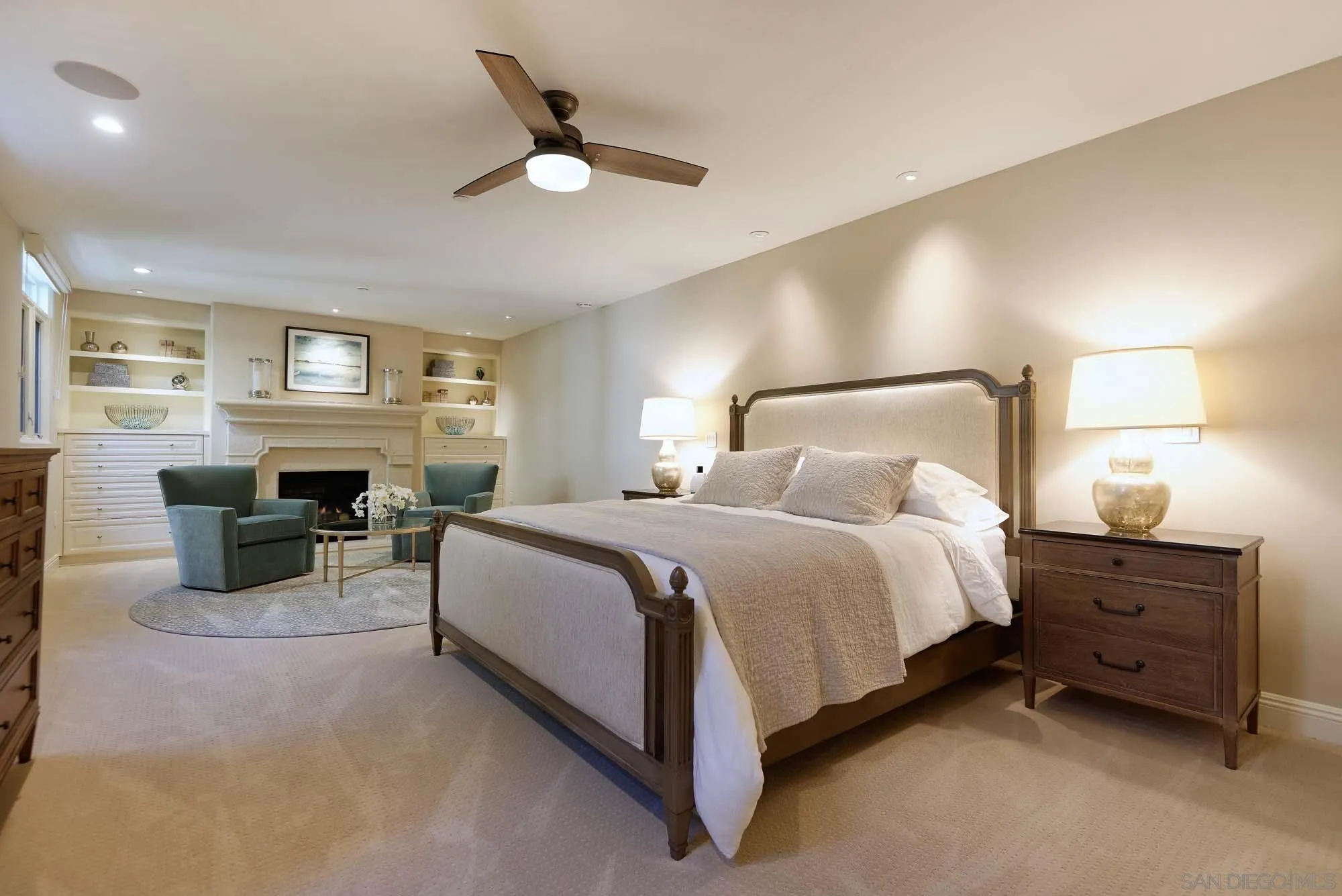 464 Prospect Street, Unit 101 La Jolla, CA 92037 - Photo 13 of 43 a spacious bedroom with a bed and a fireplace
